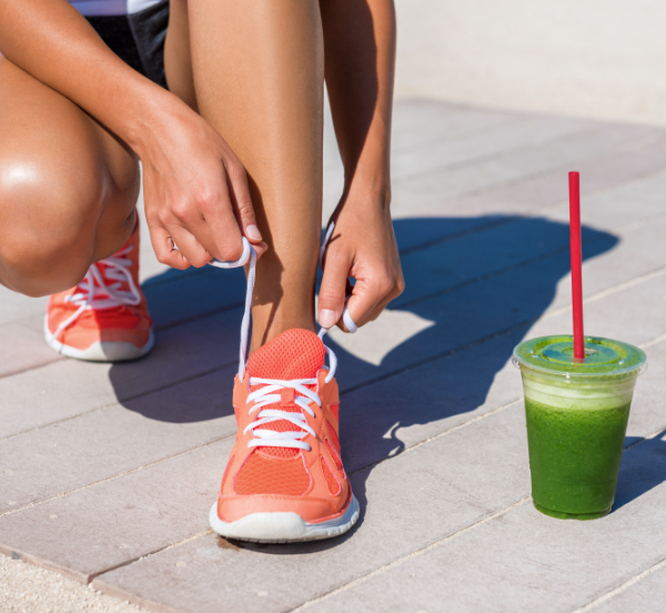 athletic woman with green smoothie