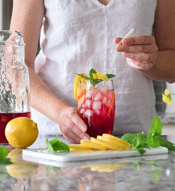 Woman making colorful iced tea