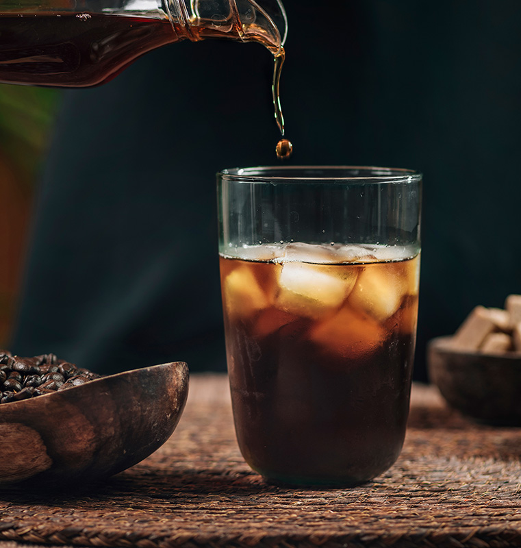 pouring iced cold brew coffee